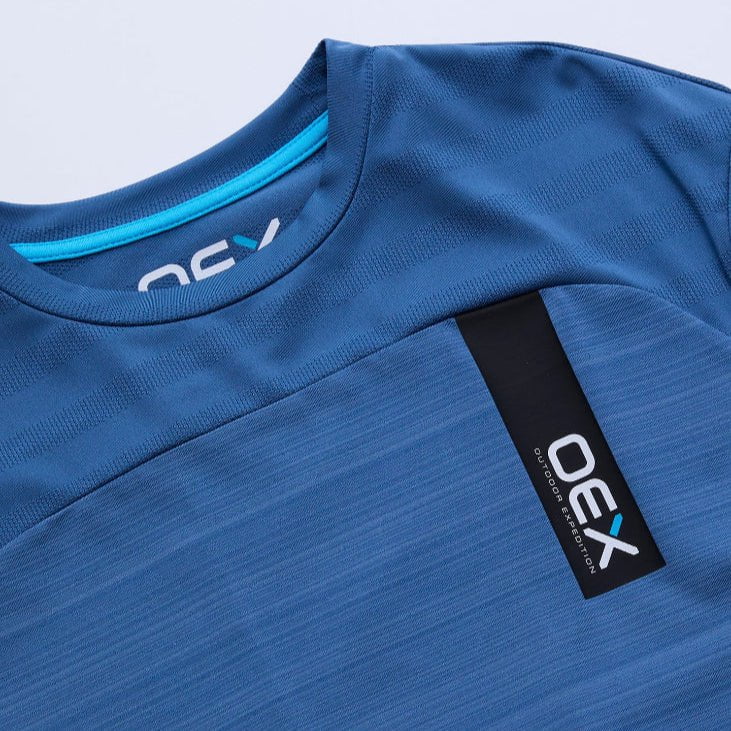 Blue athletic shirt with a visible brand tag on a light gray background