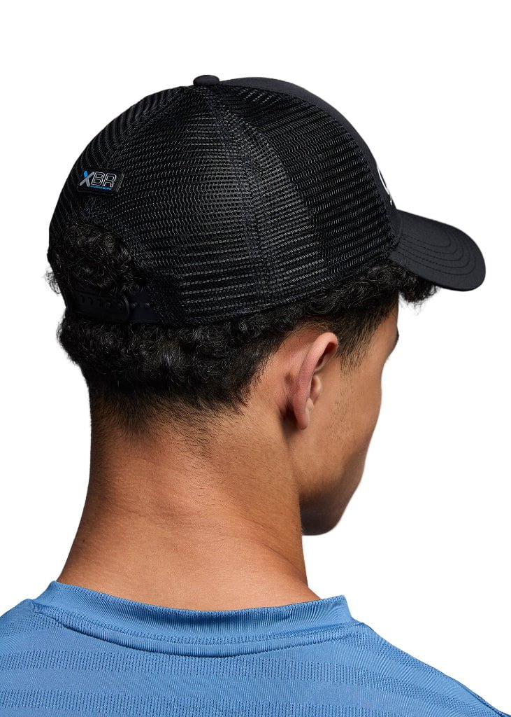 Person wearing a black mesh cap with a brand logo on a white background