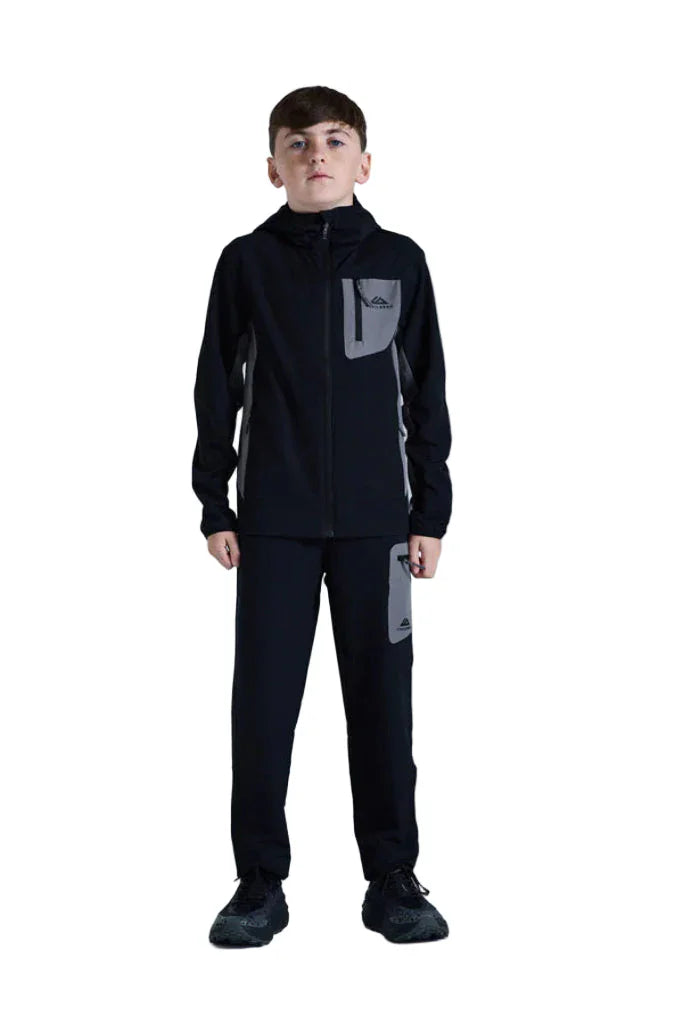 Child wearing a black tracksuit with gray accents on a white background