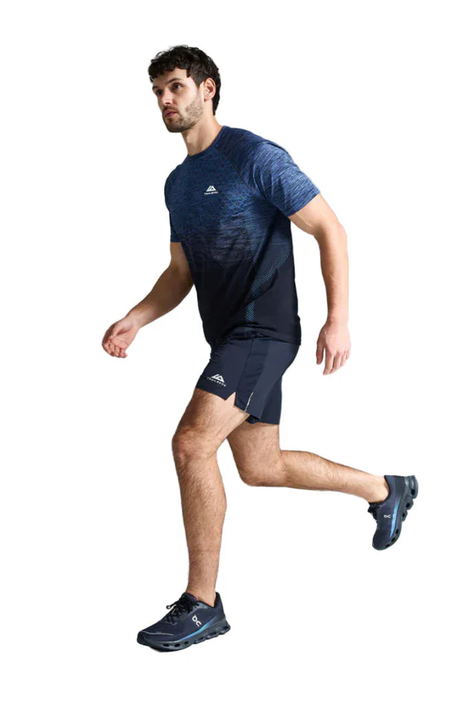 Man wearing a blue athletic outfit with a logo on a gray background