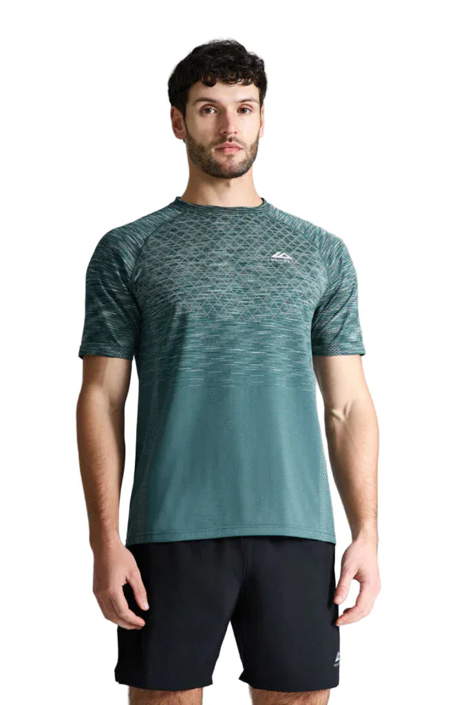 Man wearing a green athletic shirt and black shorts against a gray background