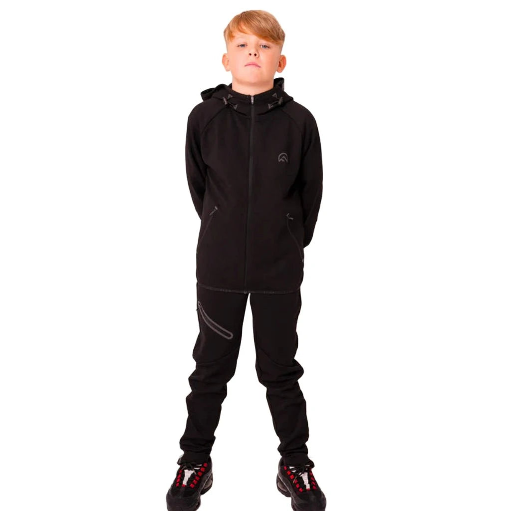 Child wearing a black tracksuit on a white background