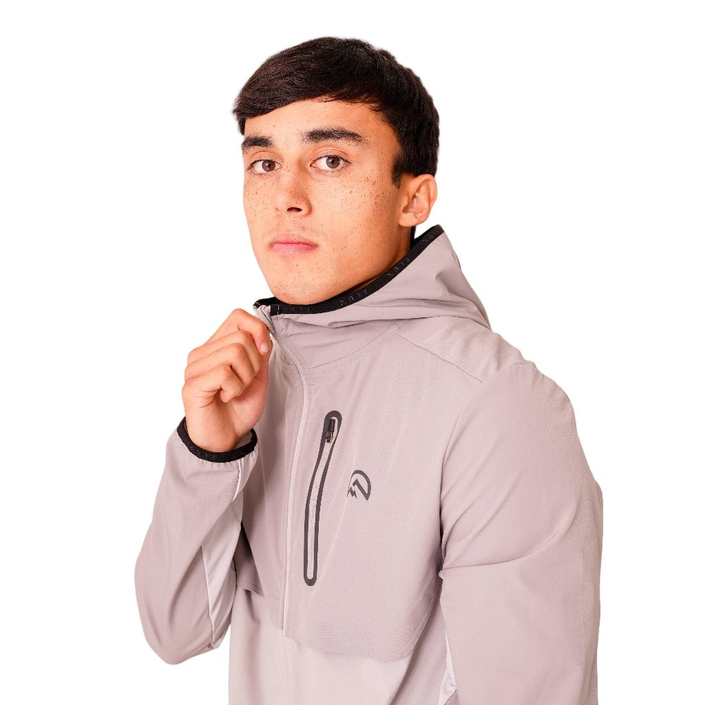 Person wearing a gray hoodie with a brand logo on a white background